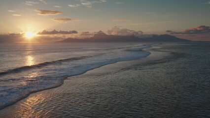 Powerful ocean waves splashing sand beach at sunset, tropical shore scenic sunrise, colorful clouds...