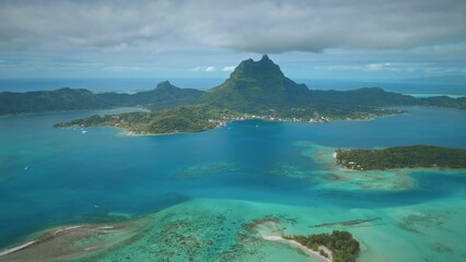 Drone capturing Bora Bora panorama, tropical island coral reef with turquoise lagoon and mount...