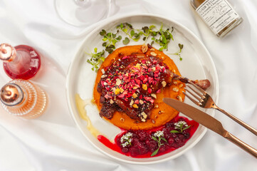 Duck Confit with Carrot Cream, Cranberry Sauce, and Hazelnut Praline