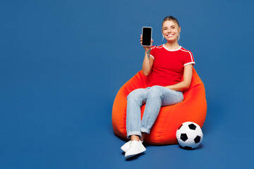 Full body young woman wear red t-shirt cheer up support football sport team hold use blank screen...