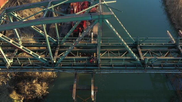 Aerial view on worker as cutting waste metal of bridge by mixing oxygen and acetylene gas, propane