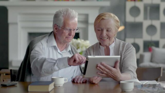 An Elderly Couple Actively Engaging and Interacting with Technology Together with Joy