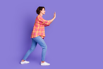 Full length profile portrait of nice young lady push empty space wear shirt isolated on purple color background