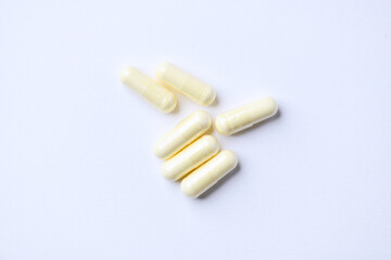 Alpha-lipoic acid capsules. Paper background. Soft focus. Close up. Copy space.