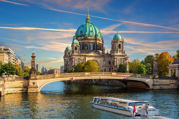 Cruise Ship is sailing near the Attractive cathedral or Berliner Dom on Museum Island, Berlin, Germany