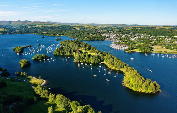 Windermere in the Lake District National Park, Cumbria, England. Aerial vista N.E. over lake centre at Bowness marinas and Belle Isle. Summer evening
