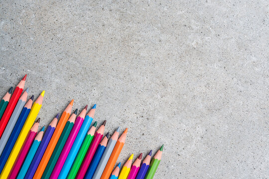 Colorful pencils on gray stone table