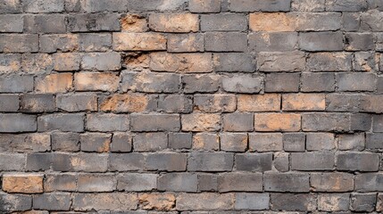 Obraz premium Weathered grey and orange brick wall with texture and imperfections ideal for design projects and backgrounds.