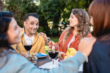 Genuine friends sharing conversation wine outdoor social authentic lifestyle gathering