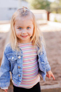 Happy little preschool girl smiling at kindergarten