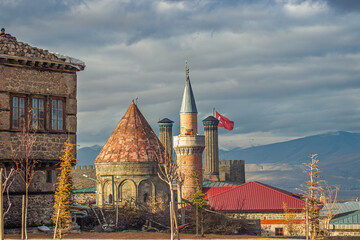Historic Twin Minaret Madrasa and Erzurum stone house with tiled minaret view