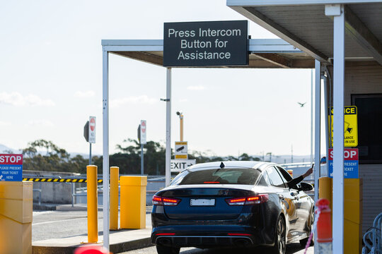 Vehicle exiting car park paying for parking at booth