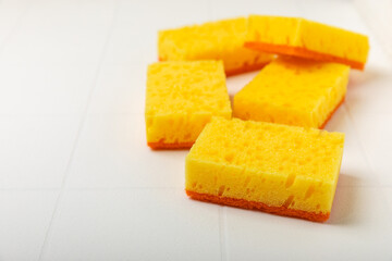 Colorful dish sponges on textured background. Kitchen sponge. Cleaning concept, cleaning service. Dishwashing liquid with clean and dirty dishes plate. Place for text, copy space. Wash the dishes.