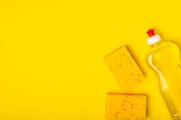 Colorful dish sponges on textured background. Kitchen sponge. Cleaning concept, cleaning service. Dishwashing liquid with clean and dirty dishes plate. Place for text, copy space. Wash the dishes.