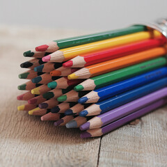Naklejka premium Colorful Wooden Pencils Stacked on Wood