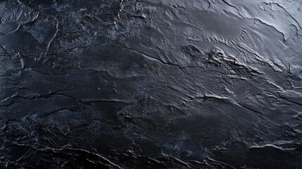 Textured black chalkboard surface with a smooth horizontal area, featuring intricate grooves and a rich, dark finish ideal for writing or artistic use.