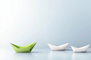 Green paper boat leading white boats on calm blue surface