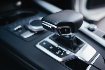 Modern brown car interior, leather steering wheel, climate control, navigation, air ducts, deflectors on the car panel, interior details.