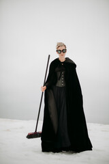 Gothic Figure in Snow with Broom and Goggles