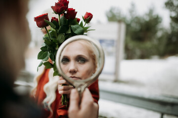 Woman Holding Mirror Reflecting Face and Roses