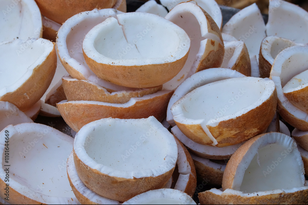 Poster close up of a pile of peeled and split coconuts with abstract patterns and textures. coconut flesh w