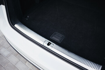 Modern brown car interior, leather steering wheel, climate control, navigation, air ducts, deflectors on the car panel, interior details.