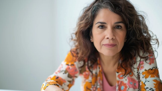 The image depicts a woman with a contemplative expression showcasing her distinctive features and attire.