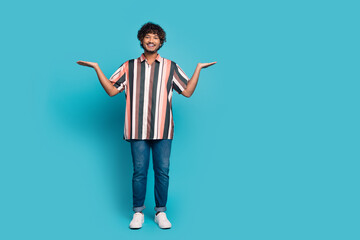 Full body portrait of nice young man hold empty space wear shirt isolated on turquoise color background