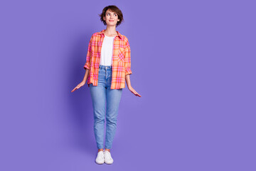 Full size photo of pretty young girl look empty space wear shirt isolated on violet color background