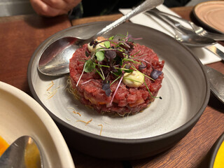 Beef steak tartare with soybean sprouds served at restaurant.