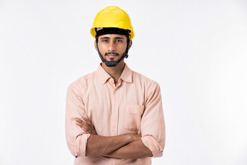 Studio portrait of a handsome construction worker with arms folded on white background