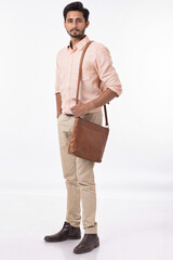 Handsome man wearing a shoulder bag at white background