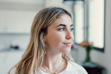 Head shot close up dreamy young smiling beautiful woman looking away, visualizing future indoors of...