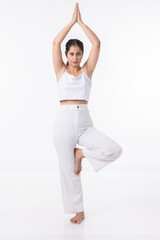 Studio shot of a young fit woman doing yoga exercises white background,