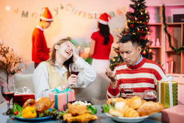 Enjoy the holiday spirit with a joyful Christmas celebration featuring friends, festive food, Santa hats,