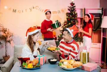 Enjoy the holiday spirit with a joyful Christmas celebration featuring friends, festive food, Santa hats,