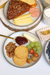 Assortment of various breakfast foods and drinks on the white table. Selective focus.