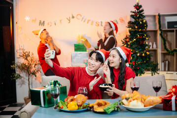 Enjoy the holiday spirit with a joyful Christmas celebration featuring friends, festive food, Santa hats,