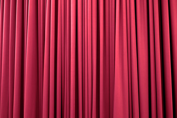 Bright pink curtain with many folds background texture