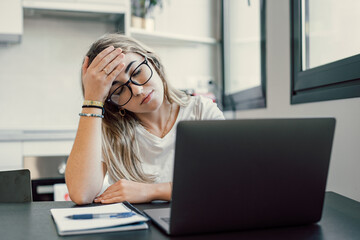 Stressed tired woman in pain having strong terrible headache attack after computer laptop study,...