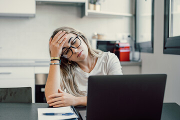 Stressed tired woman in pain having strong terrible headache attack after computer laptop study, fatigued exhausted girl suffering from chronic migraine massaging temples to relieve head ache tension.