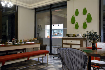 Example of the interior of a small empty restaurant or cafe with served tables. Architecture of a public space