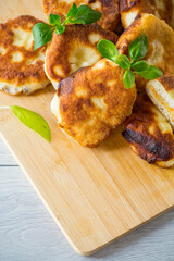 cooked fried pea pies on a wooden board
