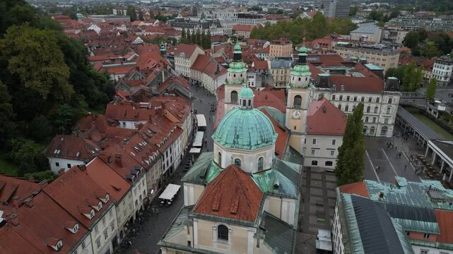 Drone fly close to the cusp of The Cathedral (Church of St. Nicholas) in old town of Ljubljana, Slovenia Europe capital city