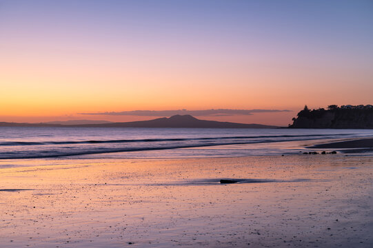 Majestic sunrise over the Rangitoto Island as view from Long Bay, Auckland, New Zealand