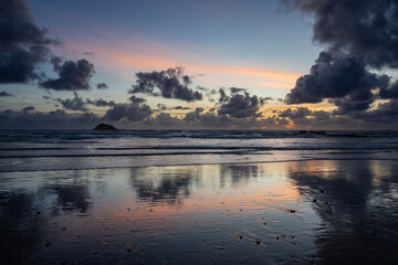 Beautiful cloud formations at Maori Bay at sunset, Auckland, New Zealand