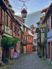 Picturesque colorful street in Kaysersberg-Vignoble with Christmas decoration - colorful half-timbered houses in snow, village near Colmar, Alsace Region, France, Alsace Wine Route