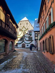 Obraz premium Kaysersberg-Vignoble with Christmas decoration - colorful half-timbered houses in snow, village near Colmar, Alsace Region, France, one of the most charming villages in France, Alsace Wine Route