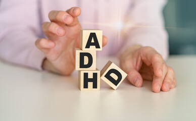 ADHD word written on wood block. ADHD text on table, concept.