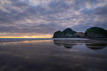 Heavenly walk at the Bethells surf beach at sunset, Auckland, New Zealand